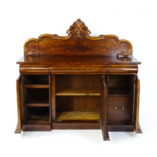 1528 - A 19thC mahogany sideboard with a carved, shaped upstand above three short drawers, the  pedestal ba... 