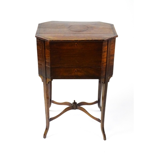 1532 - An early / mid 19thC mahogany sewing table with a crossbanded, hinged lid above a single short drawe... 