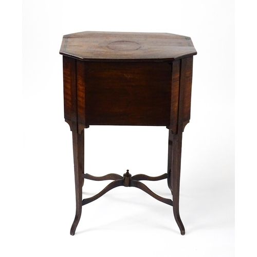 1532 - An early / mid 19thC mahogany sewing table with a crossbanded, hinged lid above a single short drawe... 