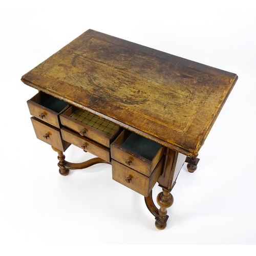 1536 - A late 17thC / early 18thC walnut lowboy with a crossbanded top above six small drawers raised on tu... 