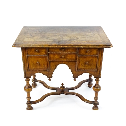 1536 - A late 17thC / early 18thC walnut lowboy with a crossbanded top above six small drawers raised on tu... 