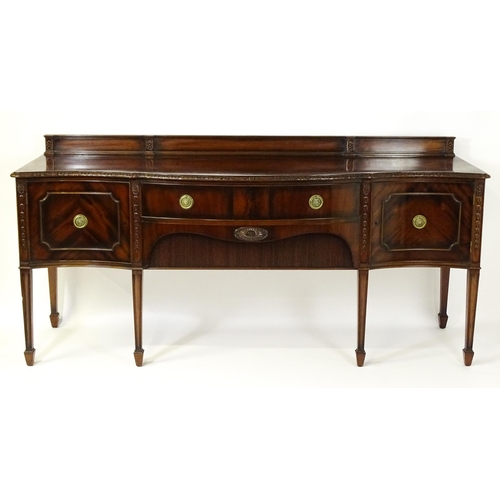 1537 - A Waring and Gillows mahogany sideboard with a floral carved upstand above a moulded edge and two pa... 