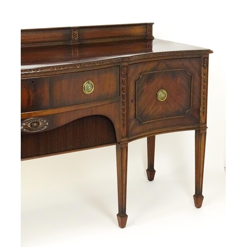 1537 - A Waring and Gillows mahogany sideboard with a floral carved upstand above a moulded edge and two pa... 