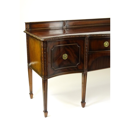 1537 - A Waring and Gillows mahogany sideboard with a floral carved upstand above a moulded edge and two pa... 