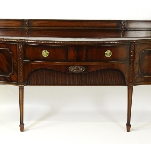 1537 - A Waring and Gillows mahogany sideboard with a floral carved upstand above a moulded edge and two pa... 