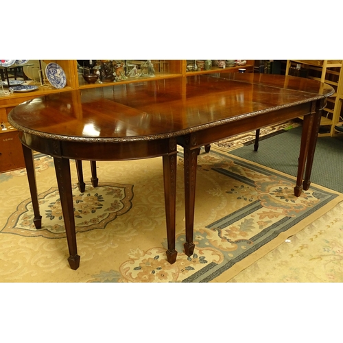 1538 - An early 20thC mahogany Waring and Gillows dining table comprised of two demi lune end tables and a ... 