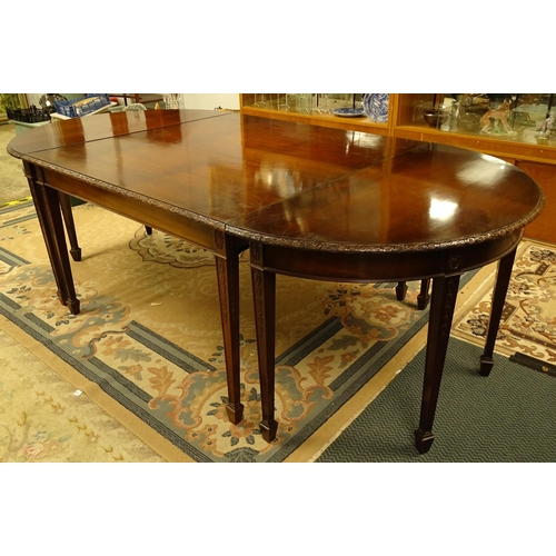 1538 - An early 20thC mahogany Waring and Gillows dining table comprised of two demi lune end tables and a ... 