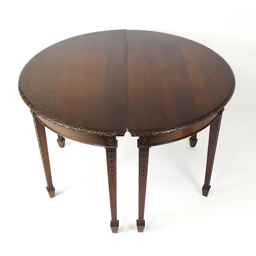 1538 - An early 20thC mahogany Waring and Gillows dining table comprised of two demi lune end tables and a ... 