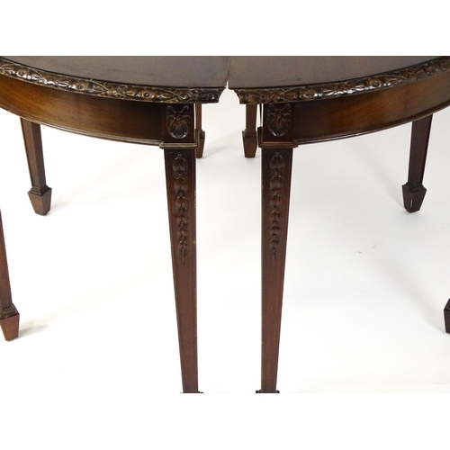 1538 - An early 20thC mahogany Waring and Gillows dining table comprised of two demi lune end tables and a ... 