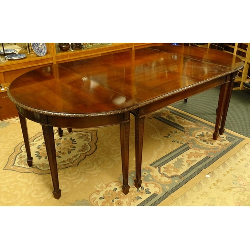 1538 - An early 20thC mahogany Waring and Gillows dining table comprised of two demi lune end tables and a ... 