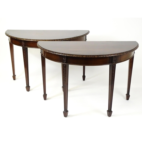 1538 - An early 20thC mahogany Waring and Gillows dining table comprised of two demi lune end tables and a ... 