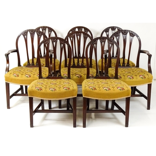 1539 - A set of eight late 19thC / early 20thC mahogany Hepplewhite style dining chairs with floral carved ... 