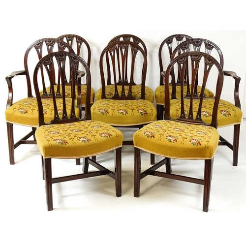 1539 - A set of eight late 19thC / early 20thC mahogany Hepplewhite style dining chairs with floral carved ... 