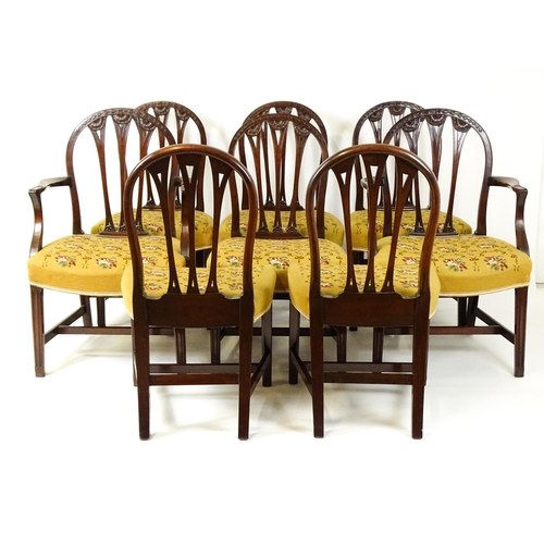 1539 - A set of eight late 19thC / early 20thC mahogany Hepplewhite style dining chairs with floral carved ... 