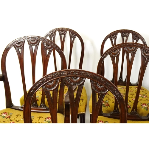 1539 - A set of eight late 19thC / early 20thC mahogany Hepplewhite style dining chairs with floral carved ... 