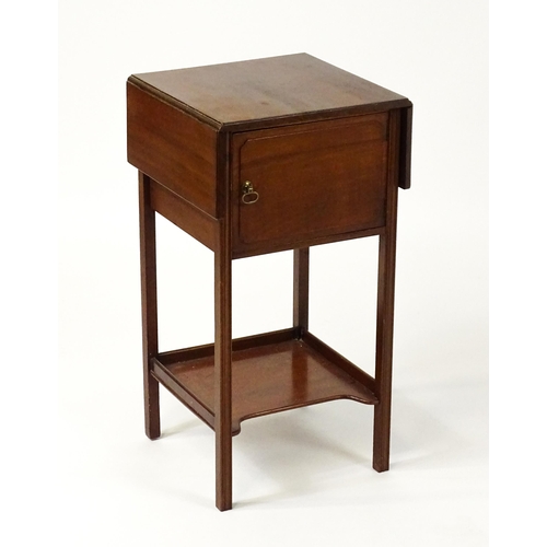 1547 - A late 19thC / early 20thC mahogany bedside cabinet / pot cupboard with two drop leaves above a sing... 