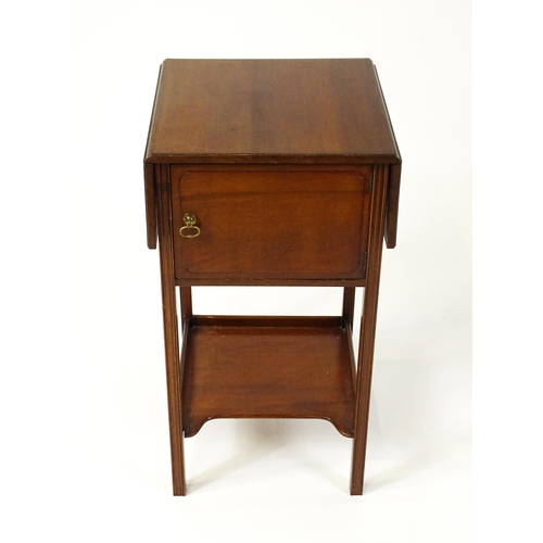 1547 - A late 19thC / early 20thC mahogany bedside cabinet / pot cupboard with two drop leaves above a sing... 