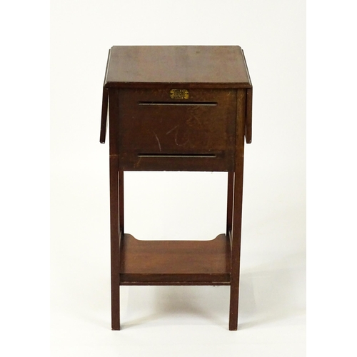 1547 - A late 19thC / early 20thC mahogany bedside cabinet / pot cupboard with two drop leaves above a sing... 