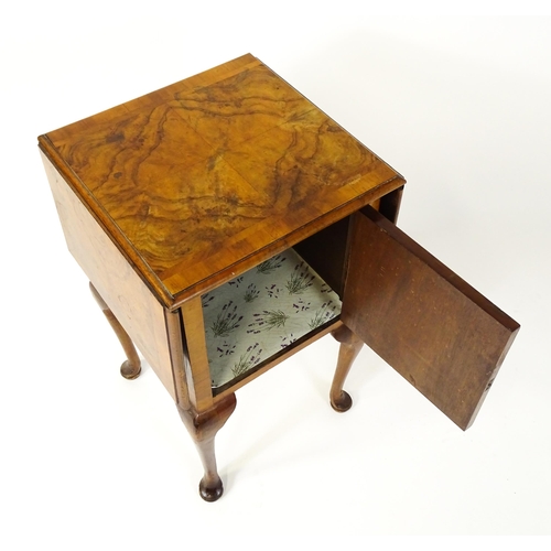 1548 - An early 20thC walnut bedside cabinet / pot cupboard with a crossbanded top having two drop leaves a... 