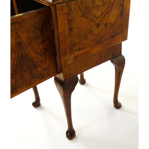 1548 - An early 20thC walnut bedside cabinet / pot cupboard with a crossbanded top having two drop leaves a... 