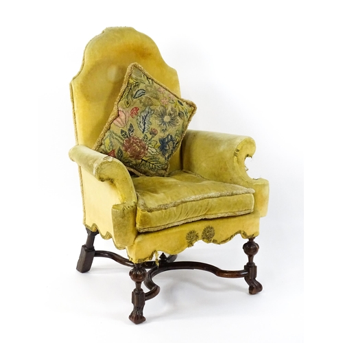 1556 - A 19thC William and Mary style armchair with a shaped backrest, scrolled arms raised on carved front... 