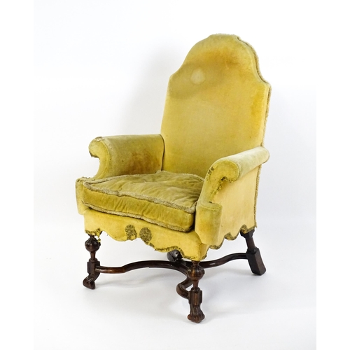 1556 - A 19thC William and Mary style armchair with a shaped backrest, scrolled arms raised on carved front... 