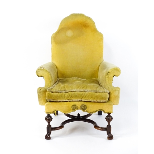 1556 - A 19thC William and Mary style armchair with a shaped backrest, scrolled arms raised on carved front... 