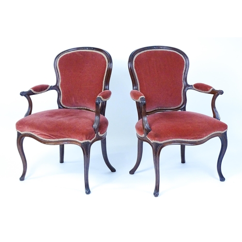 1567 - A pair of 19thC fauteuil armchairs with a carved cresting rail and arms raised on shaped seat rails ... 