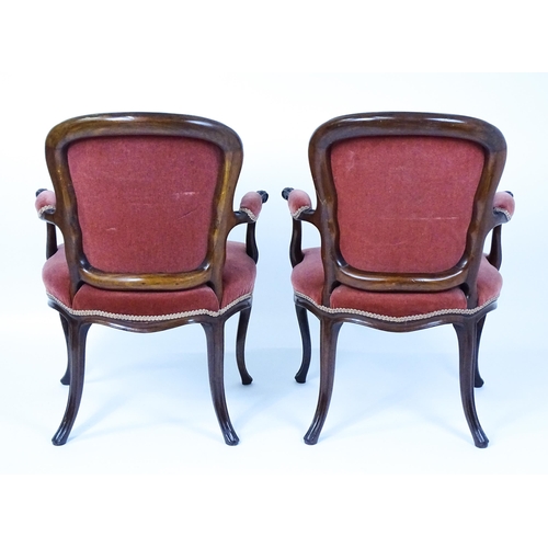 1567 - A pair of 19thC fauteuil armchairs with a carved cresting rail and arms raised on shaped seat rails ... 