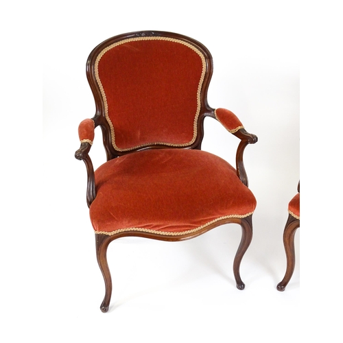 1567 - A pair of 19thC fauteuil armchairs with a carved cresting rail and arms raised on shaped seat rails ... 