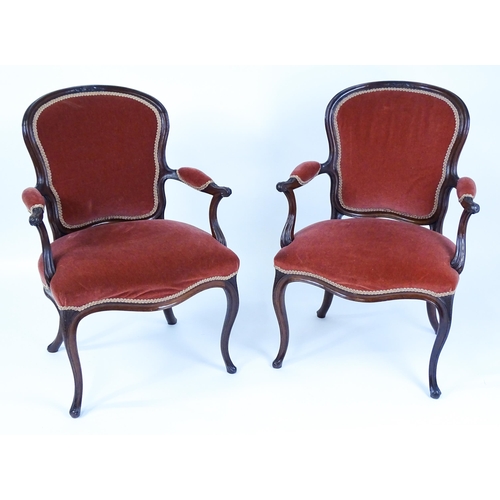 1567 - A pair of 19thC fauteuil armchairs with a carved cresting rail and arms raised on shaped seat rails ... 