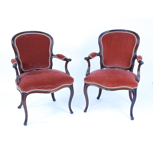 1567 - A pair of 19thC fauteuil armchairs with a carved cresting rail and arms raised on shaped seat rails ... 