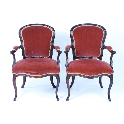 1567 - A pair of 19thC fauteuil armchairs with a carved cresting rail and arms raised on shaped seat rails ... 