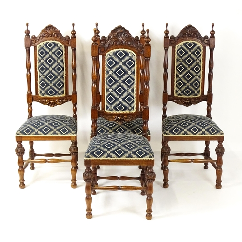 1579 - A set of four early 20thC dining chairs with carved cresting rails and surmounted by turned finials,... 