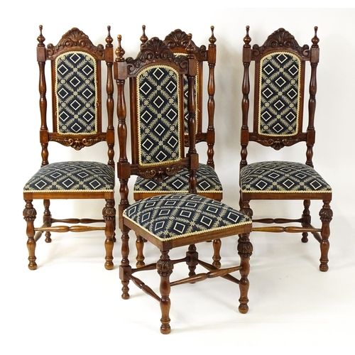 1579 - A set of four early 20thC dining chairs with carved cresting rails and surmounted by turned finials,... 