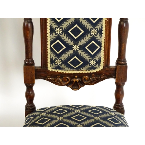 1579 - A set of four early 20thC dining chairs with carved cresting rails and surmounted by turned finials,... 