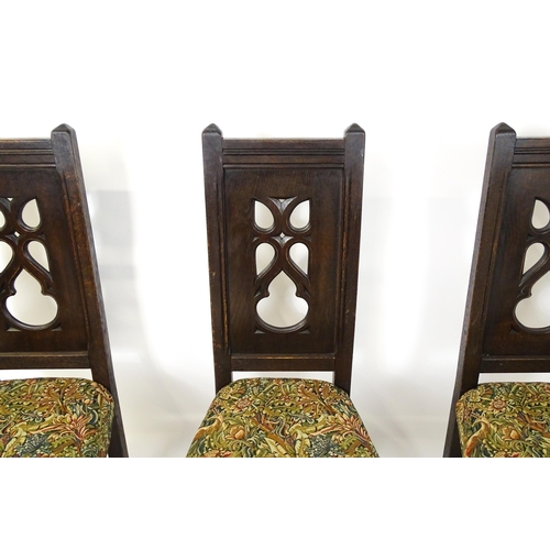 1580 - A set of four late 19thC Gothic revival chairs, having pierced back splits. Morris upholstery and ra... 