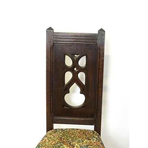 1580 - A set of four late 19thC Gothic revival chairs, having pierced back splits. Morris upholstery and ra... 