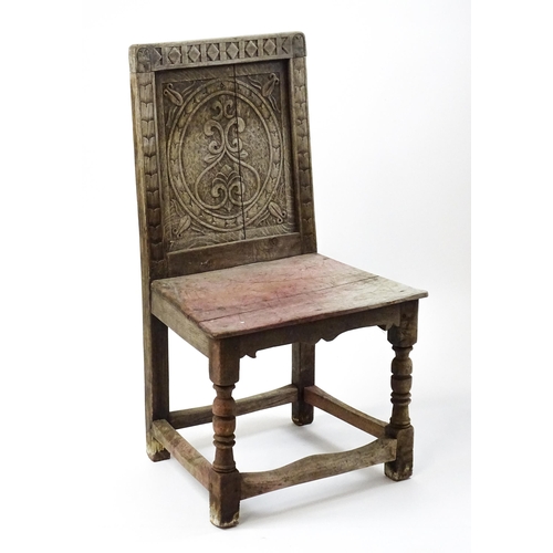 1605 - A medieval revival side chair with a carved panelled backrest, above turned tapering front legs and ... 