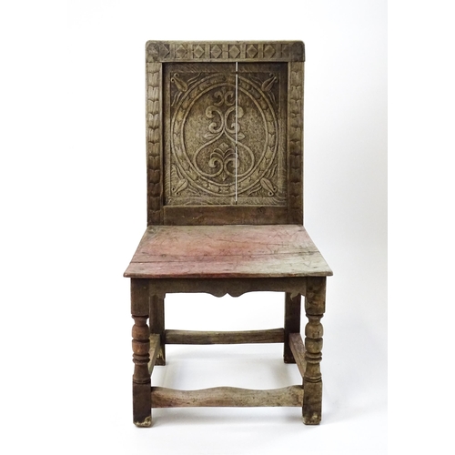 1605 - A medieval revival side chair with a carved panelled backrest, above turned tapering front legs and ... 