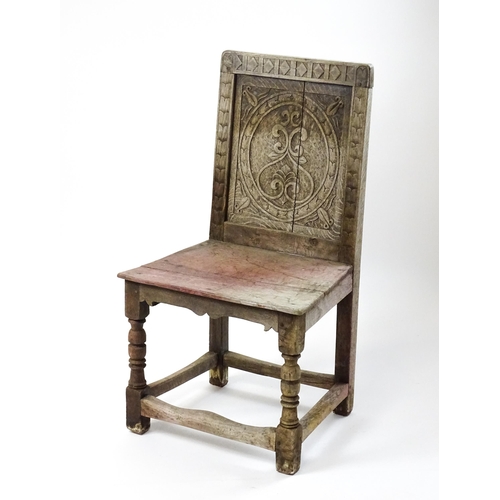 1605 - A medieval revival side chair with a carved panelled backrest, above turned tapering front legs and ... 