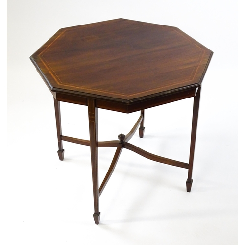 1609 - An Edwardian mahogany occasional table with an octagonal top above four tapering legs terminating in... 