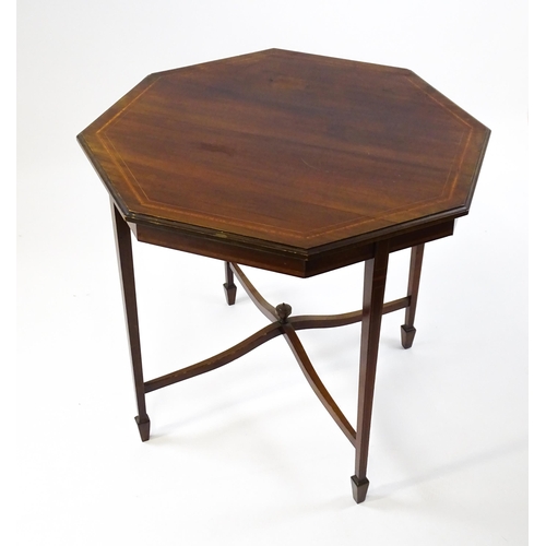 1609 - An Edwardian mahogany occasional table with an octagonal top above four tapering legs terminating in... 