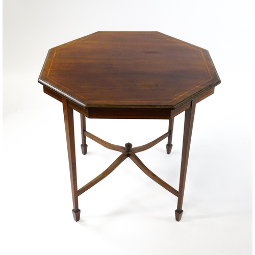 1609 - An Edwardian mahogany occasional table with an octagonal top above four tapering legs terminating in... 