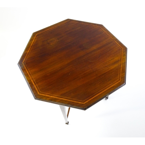 1609 - An Edwardian mahogany occasional table with an octagonal top above four tapering legs terminating in... 