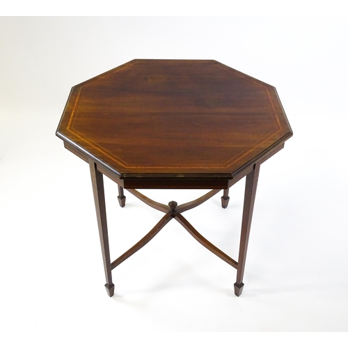 1609 - An Edwardian mahogany occasional table with an octagonal top above four tapering legs terminating in... 