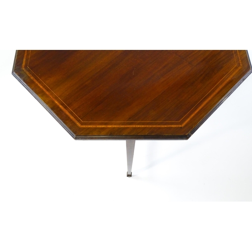 1609 - An Edwardian mahogany occasional table with an octagonal top above four tapering legs terminating in... 