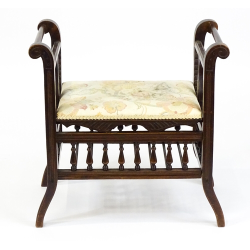 1622 - An Edwardian piano stool with scrolled uprights and vase shaped supports above an adjustable seat an... 