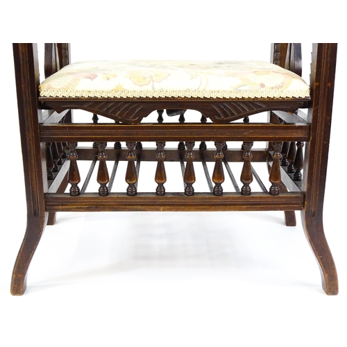 1622 - An Edwardian piano stool with scrolled uprights and vase shaped supports above an adjustable seat an... 