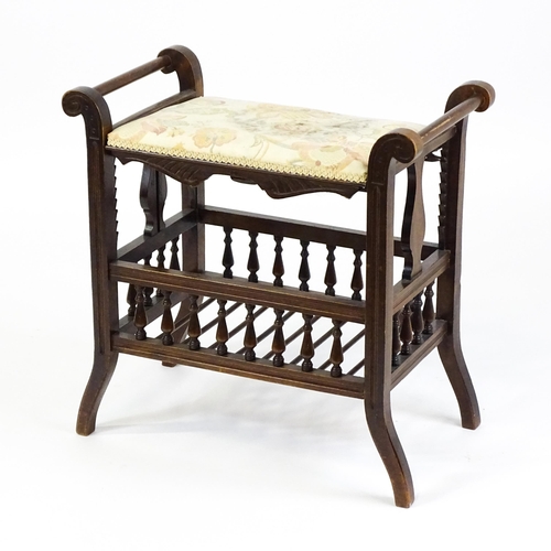 1622 - An Edwardian piano stool with scrolled uprights and vase shaped supports above an adjustable seat an... 